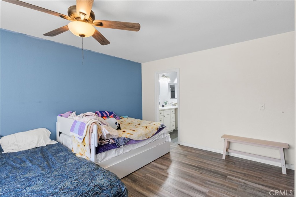 8548 Turlock Drive Riverside, CA 92504 - Photo 32 of 56 a bedroom with a bed and a chandelier