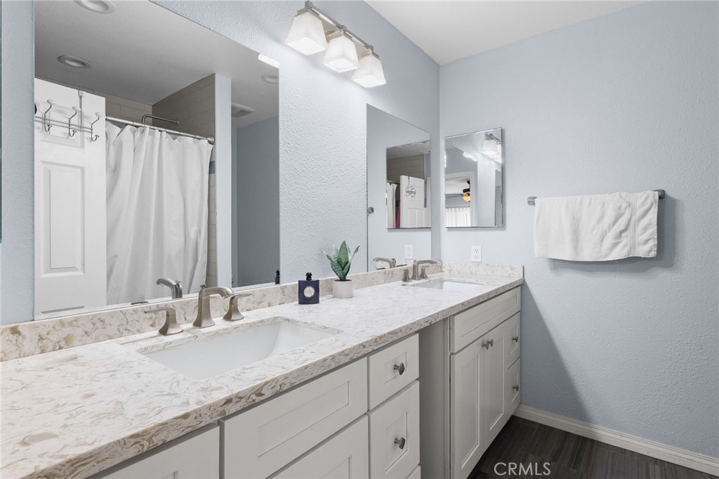 8548 Turlock Drive Riverside, CA 92504 - Photo 33 of 56 a bathroom with a granite countertop sink and a mirror