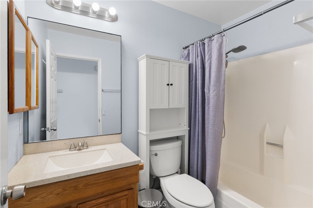 8548 Turlock Drive Riverside, CA 92504 - Photo 36 of 56 a bathroom with a sink a toilet and shower