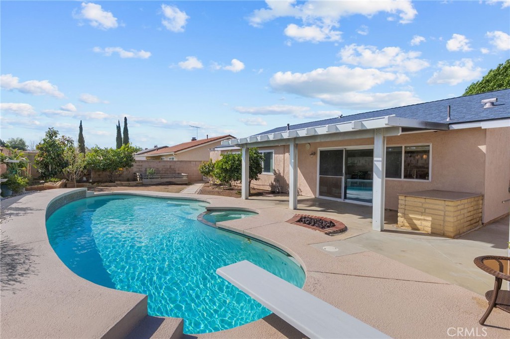 8548 Turlock Drive Riverside, CA 92504 - Photo 40 of 56 a view of a house with backyard sitting area and garden
