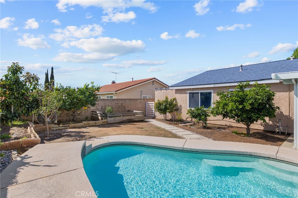 8548 Turlock Drive Riverside, CA 92504 - Photo 43 of 56 a swimming pool with outdoor seating and yard