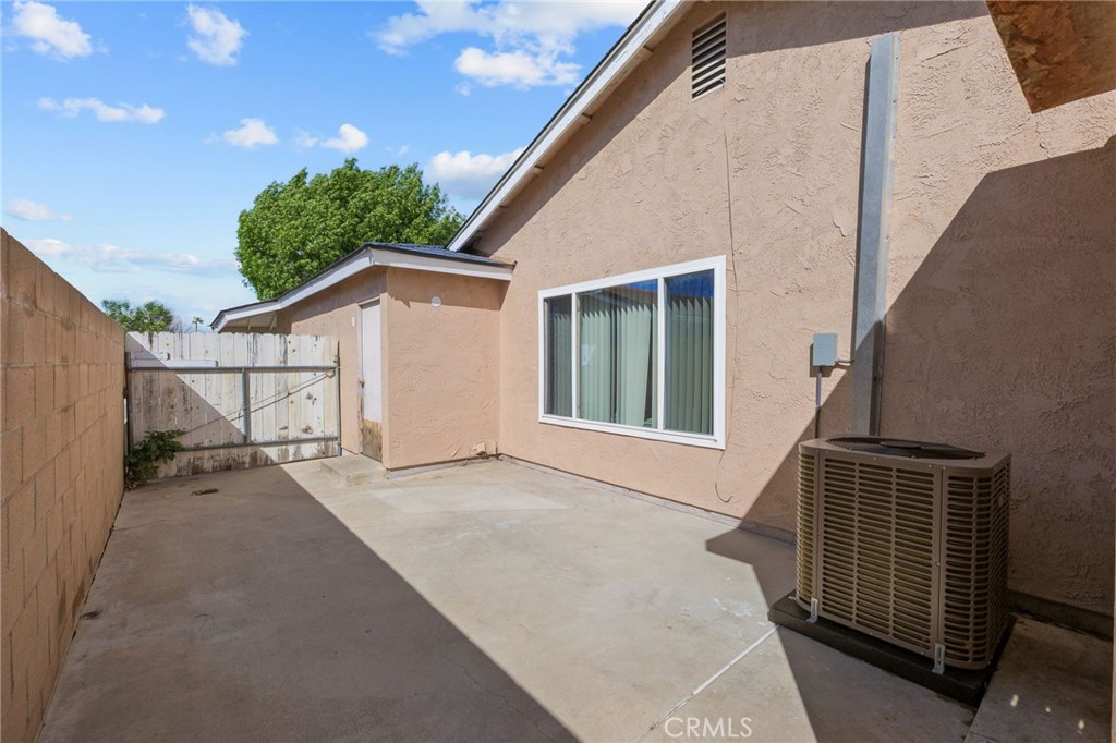 8548 Turlock Drive Riverside, CA 92504 - Photo 46 of 56 a backyard of a house with wooden floor and fence