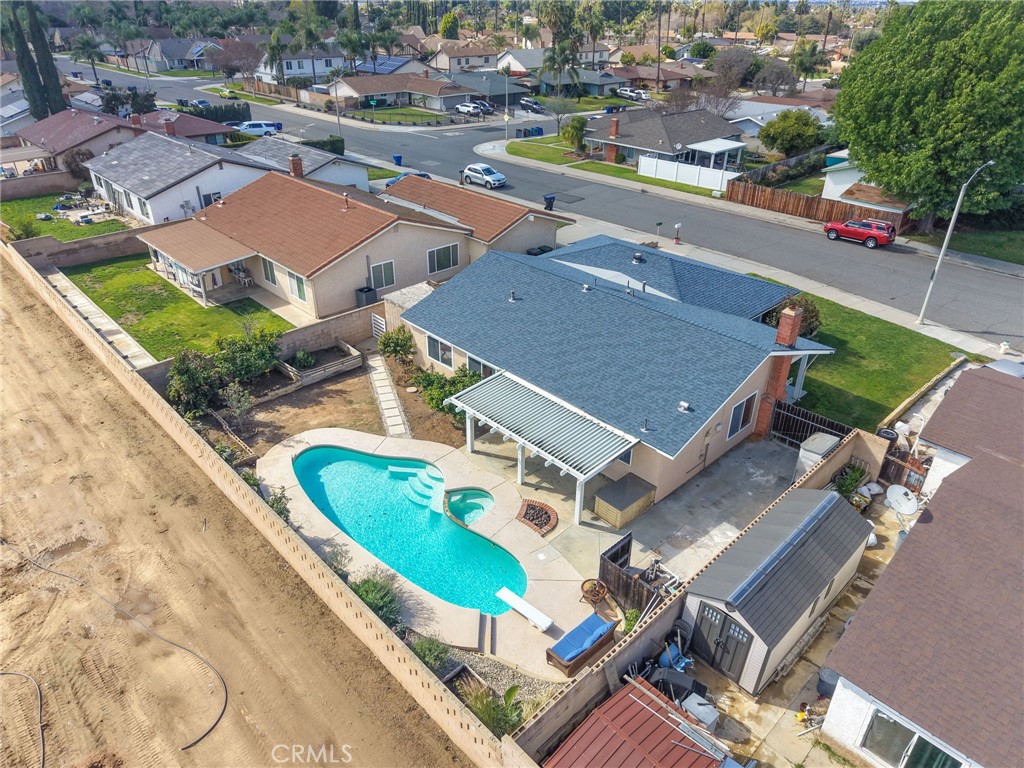 8548 Turlock Drive Riverside, CA 92504 - Photo 49 of 56 an aerial view of a house with a swimming pool and outdoor seating