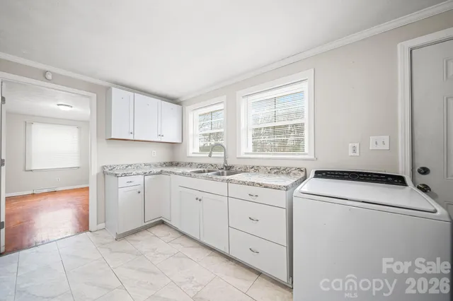 a utility room with cabinets washer and dryer