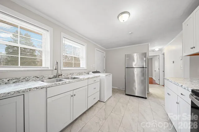 a kitchen with a refrigerator and a sink