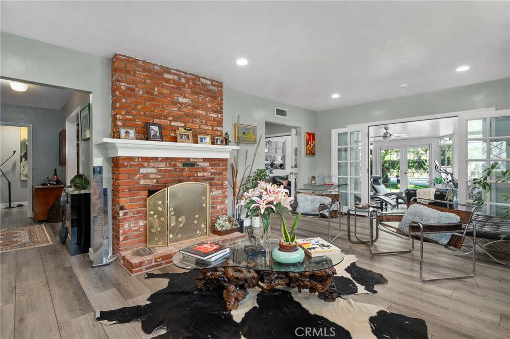 5180 Stonewood Drive Riverside, CA 92506 - Photo 13 of 49 a living room with furniture a fireplace and large windows
