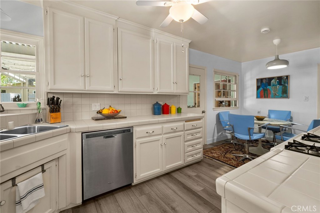 5180 Stonewood Drive Riverside, CA 92506 - Photo 15 of 49 a kitchen with white cabinets and appliances