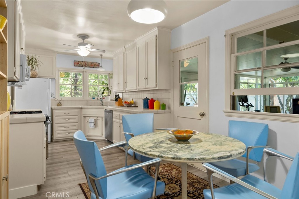 5180 Stonewood Drive Riverside, CA 92506 - Photo 19 of 49 a view of a dining room with furniture and a kitchen