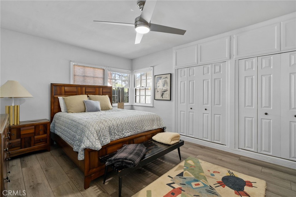 5180 Stonewood Drive Riverside, CA 92506 - Photo 24 of 49 a bedroom with a bed and a chandelier