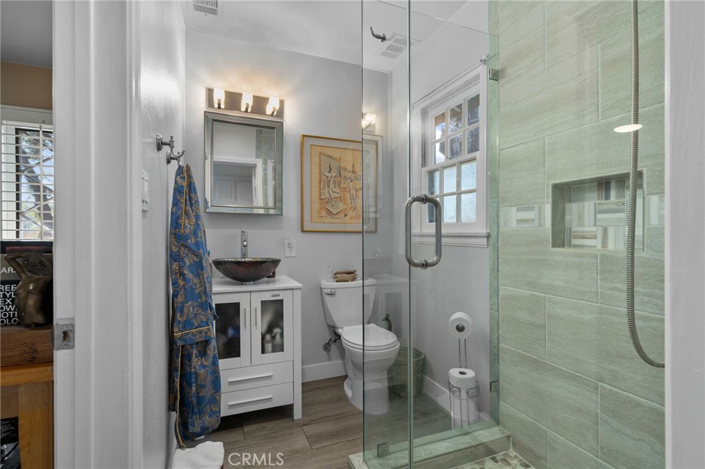 5180 Stonewood Drive Riverside, CA 92506 - Photo 33 of 49 a bathroom with a sink a toilet and shower