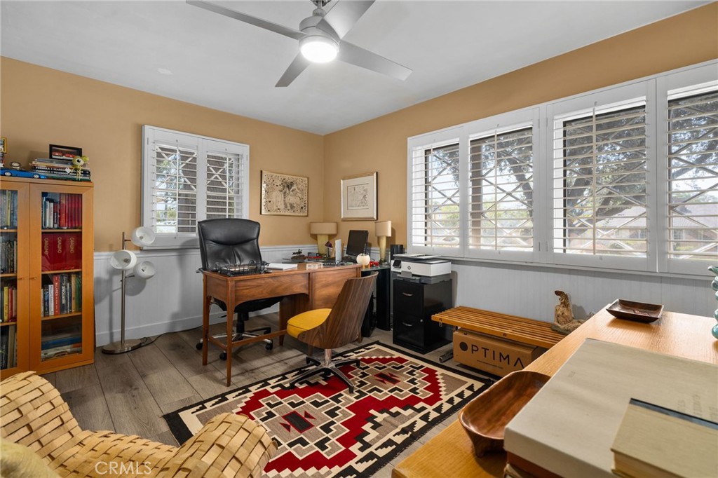 5180 Stonewood Drive Riverside, CA 92506 - Photo 36 of 49 a living room with furniture a bookshelf and a window