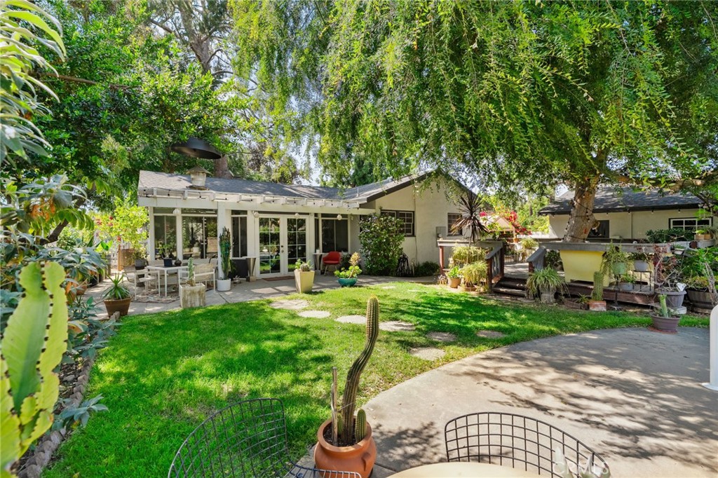 5180 Stonewood Drive Riverside, CA 92506 - Photo 38 of 49 a view of a house with backyard sitting area and garden