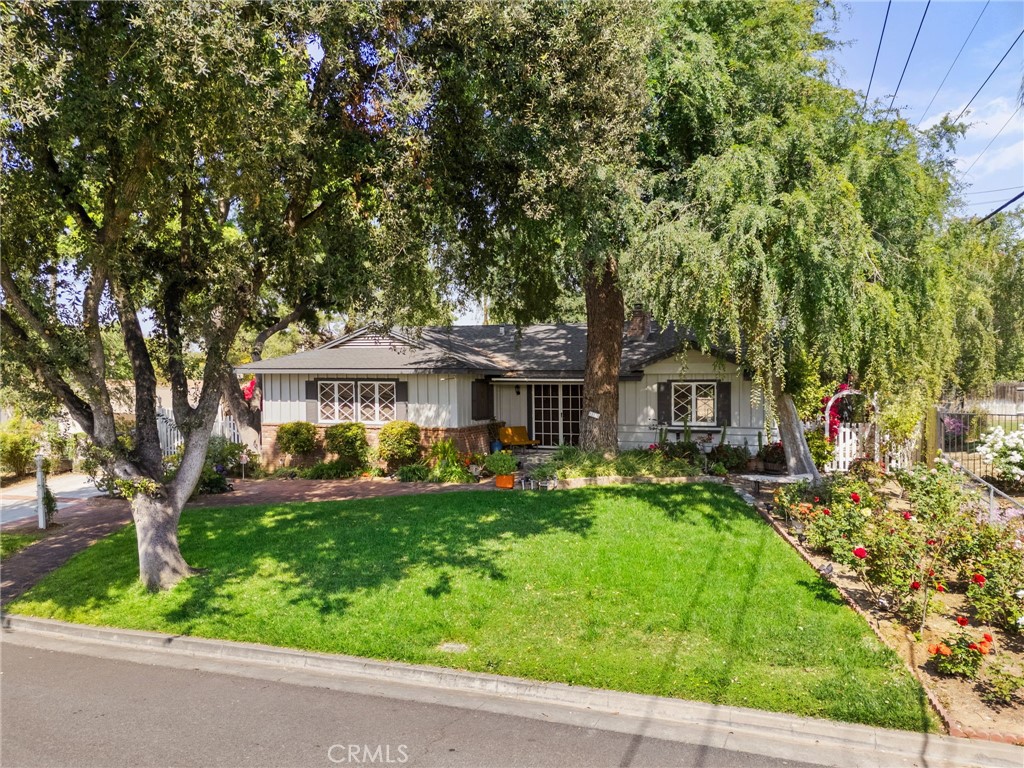 5180 Stonewood Drive Riverside, CA 92506 - Photo 43 of 49 a front view of a house with a yard table and chairs