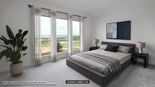 a bedroom with a large bed and a potted plant