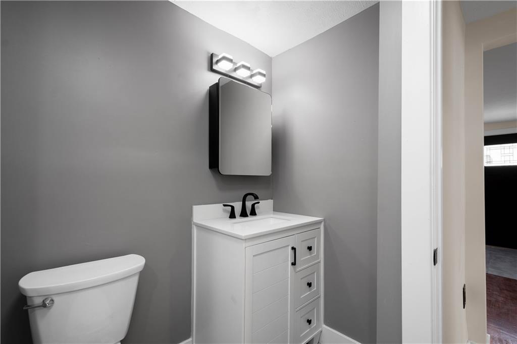933 Boyce Road Bridgeville, PA 15017 - Photo 18 of 36 a bathroom with a toilet sink and mirror