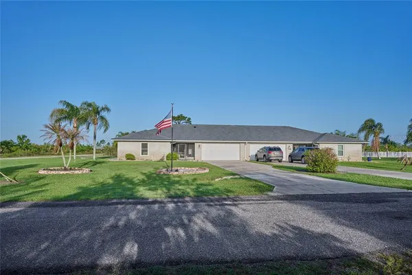 a front view of a house with a yard and a garage