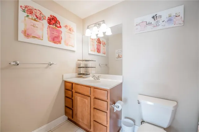 a bathroom with a sink mirror vanity and toilet