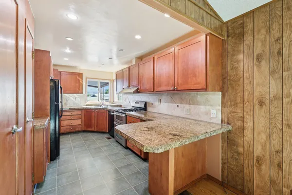 a kitchen with a refrigerator and cabinets