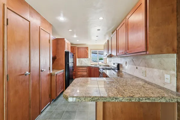 a kitchen with a stove and a refrigerator