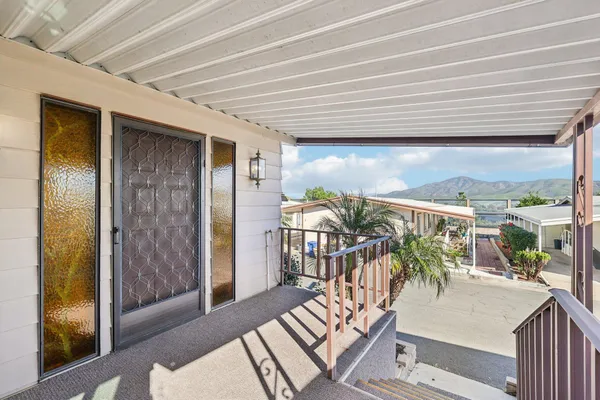 a balcony with table and chairs
