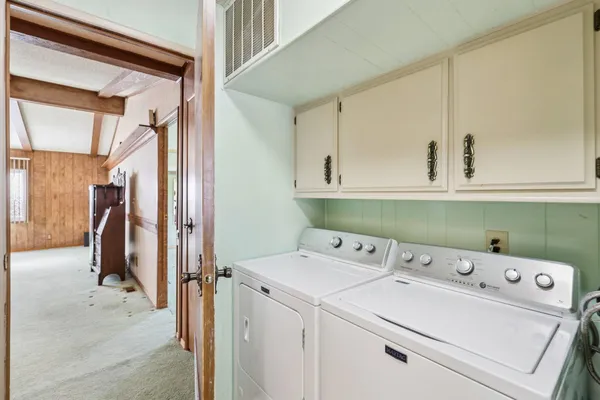 a bedroom with two beds and window