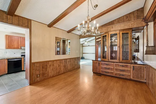 a spacious bedroom with a bed and a dresser