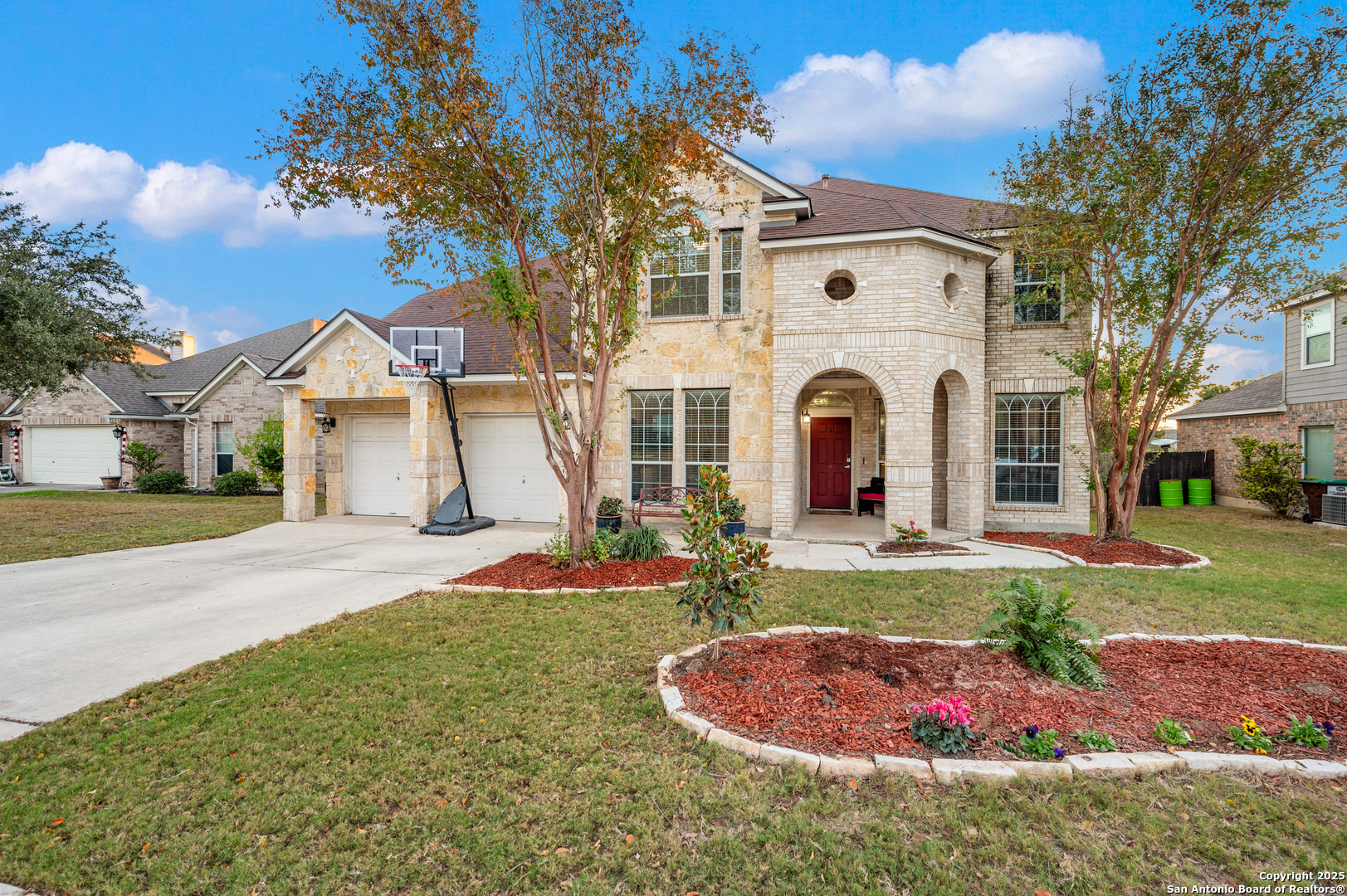10414 Rainbow View Helotes, TX 78023 - Photo 1 of 38 a front view of a house with a yard and garage