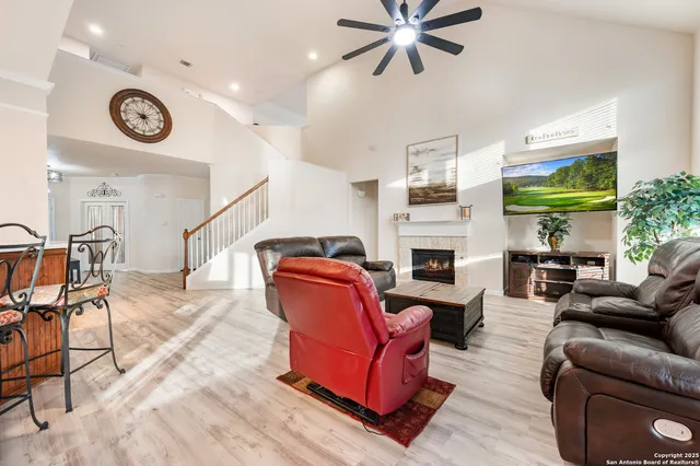 a living room with furniture a fireplace and a window
