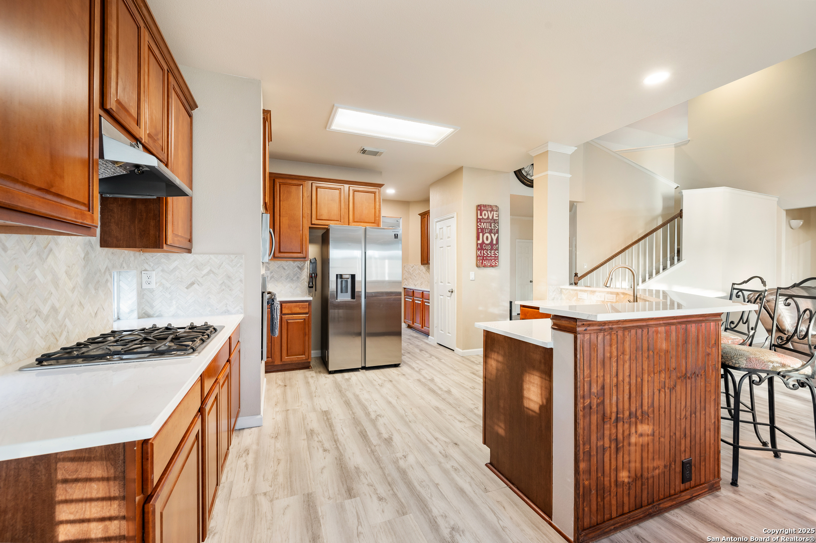 10414 Rainbow View Helotes, TX 78023 - Photo 13 of 38 a kitchen with stainless steel appliances a stove a sink and a refrigerator