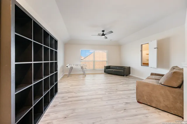a living room with furniture window and wooden floor