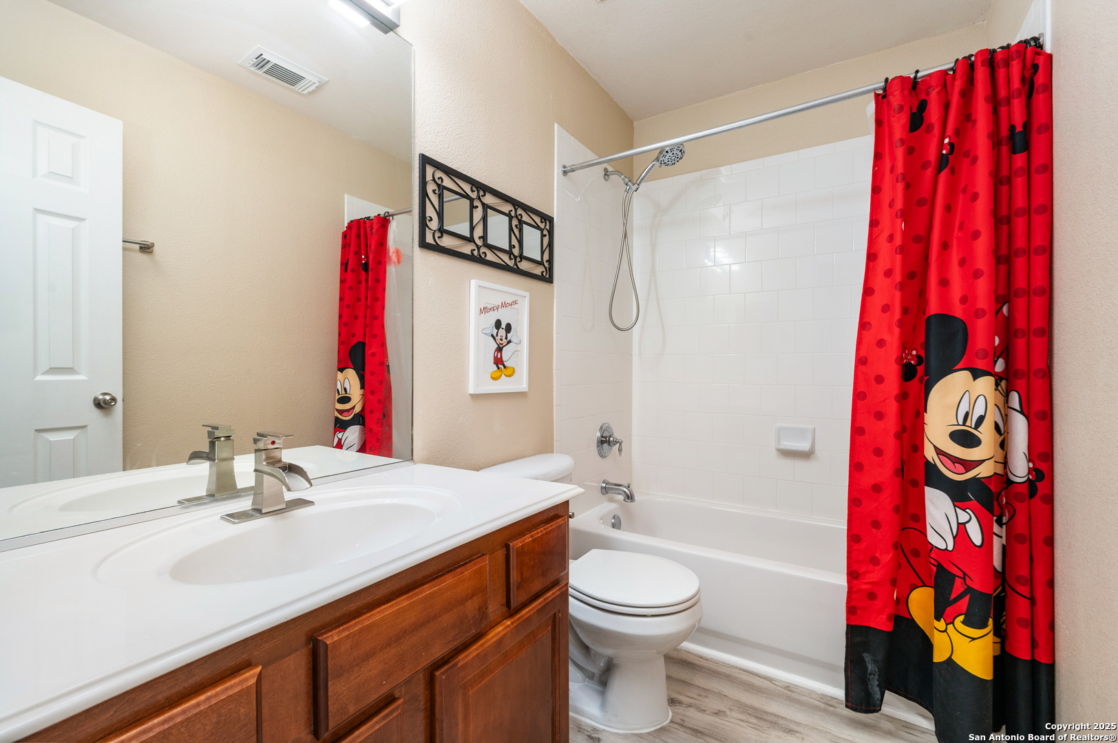 10414 Rainbow View Helotes, TX 78023 - Photo 29 of 38 a bathroom with a sink vanity mirror and a bathtub