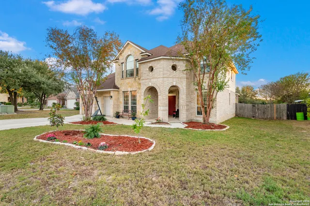 a view of a white house with a sink and yard with swimming pool