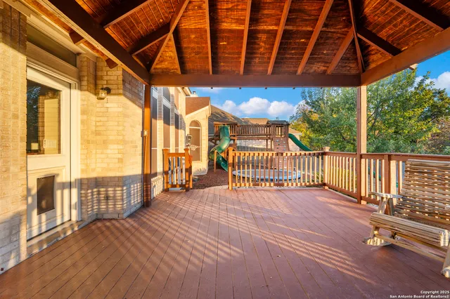 a view of a porch with wooden floor and iron stairs