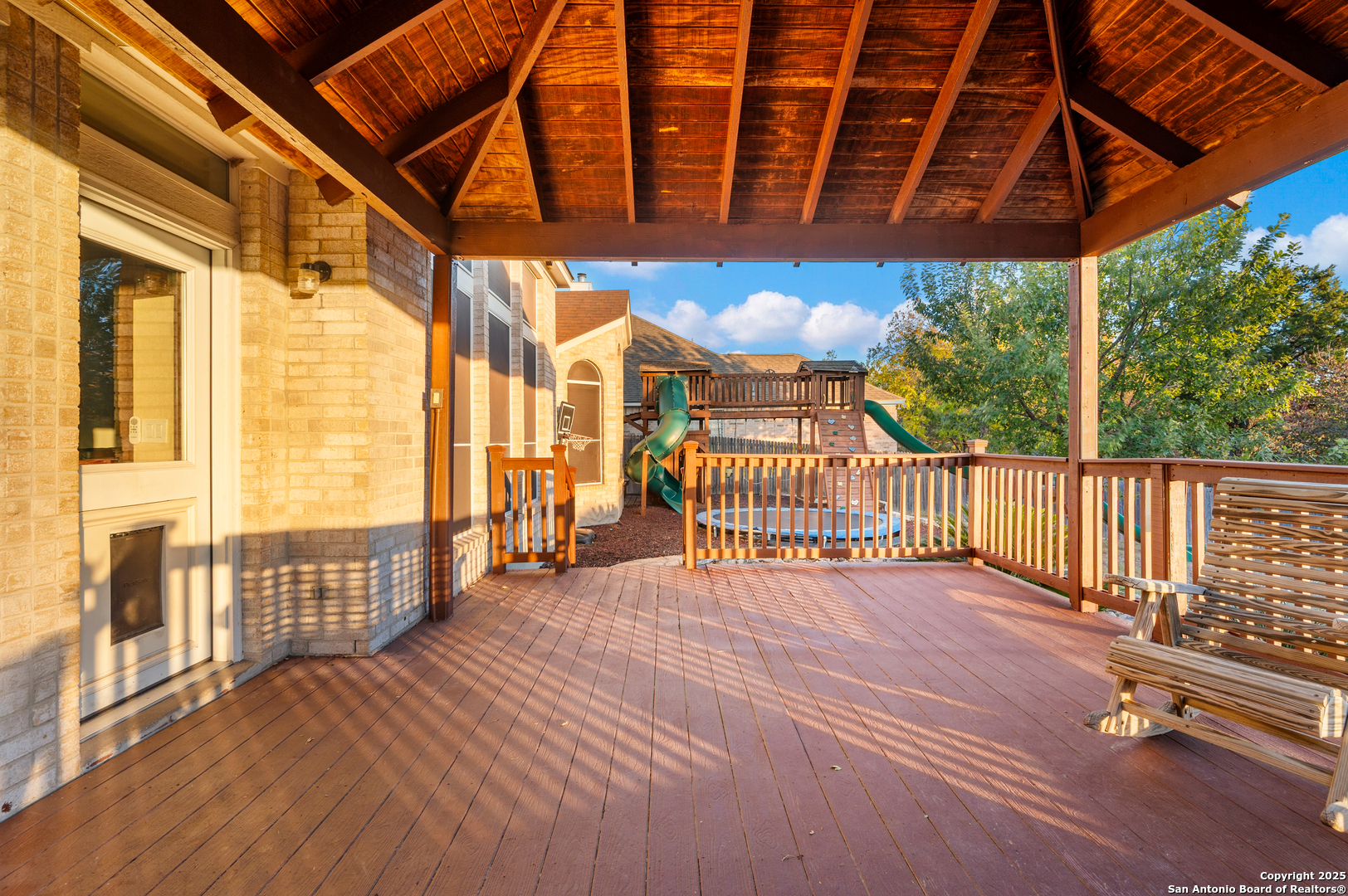 10414 Rainbow View Helotes, TX 78023 - Photo 34 of 38 a view of a porch with wooden floor and iron stairs