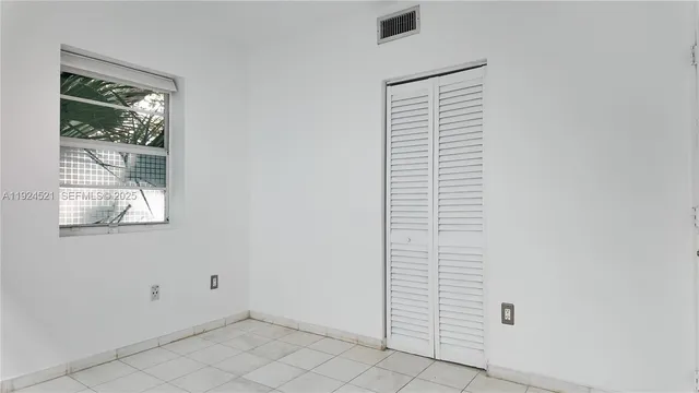 a kitchen with cabinets stainless steel appliances and a window
