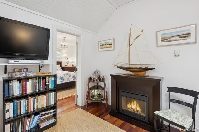 a living room with fireplace and a flat screen tv