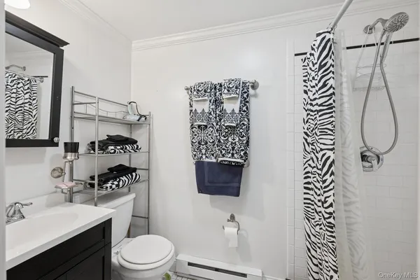 a bathroom with a toilet sink and shower