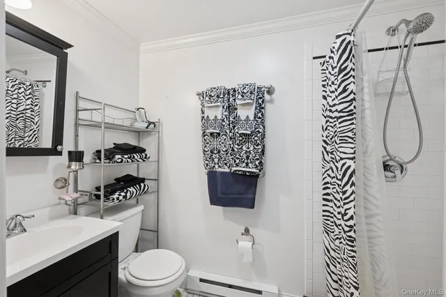 a bathroom with a toilet sink and shower
