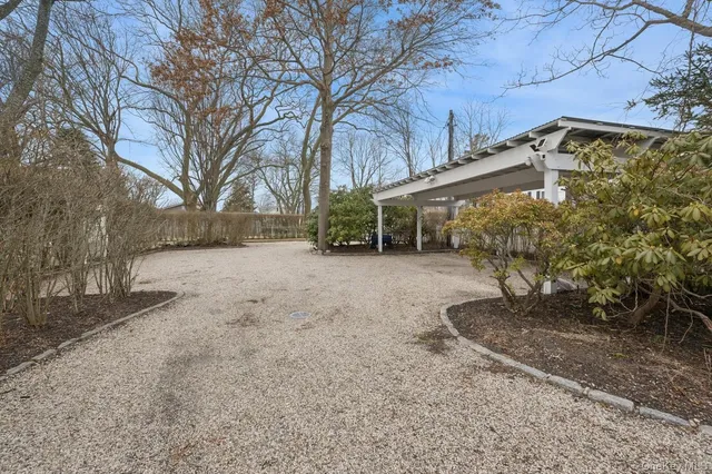 a dirt road with a building in the background