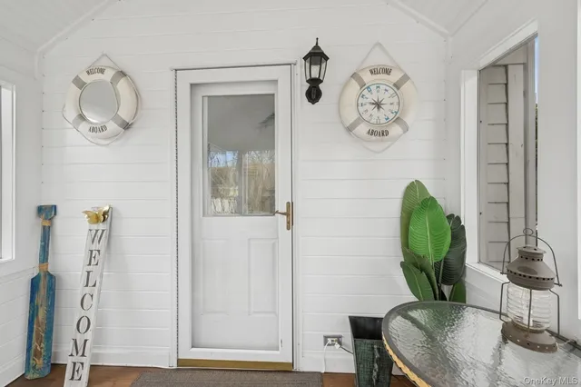 a living room with furniture and a mirror