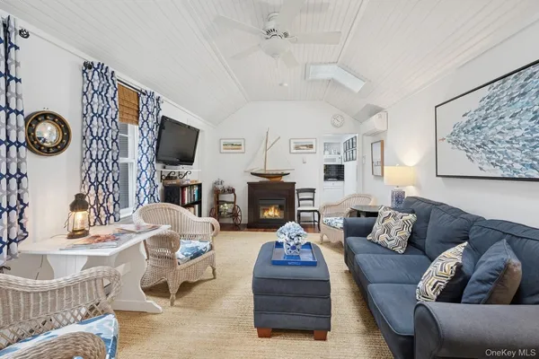 a living room with fireplace furniture and a flat screen tv