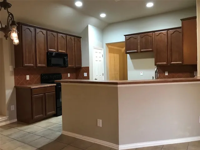 a kitchen with a refrigerator and a microwave