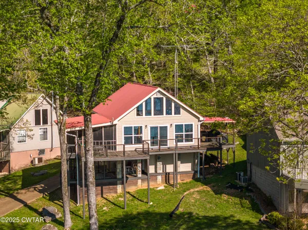 a house with tall trees in the background
