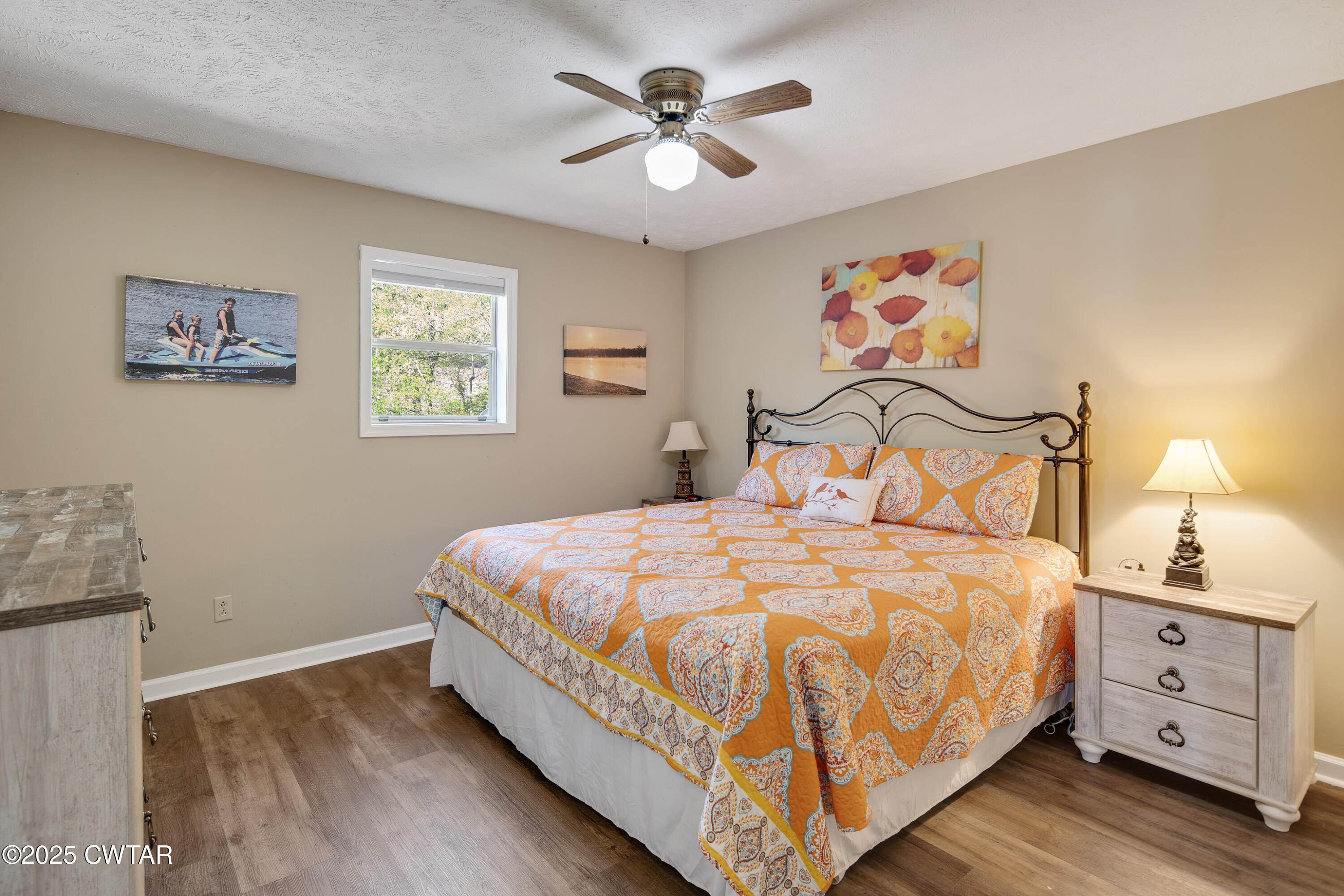 229 Bill Perry Drive Sugar Tree, TN 38380 - Photo 17 of 42 a bedroom with a bed and a chandelier