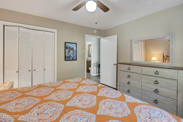 a bedroom with a bed and a dresser in it