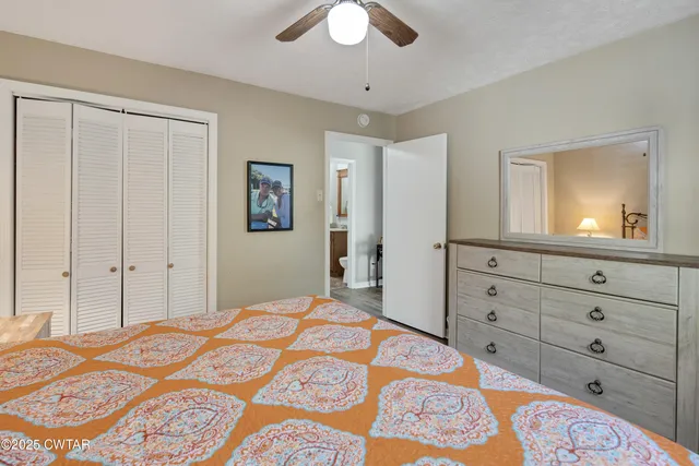 a bedroom with a bed and a dresser in it