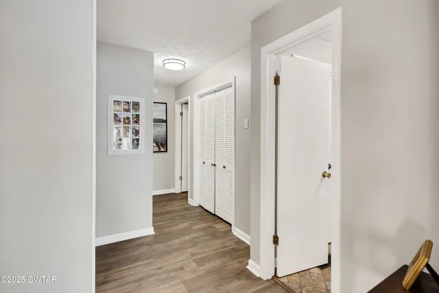 a view of a hallway with wooden floor
