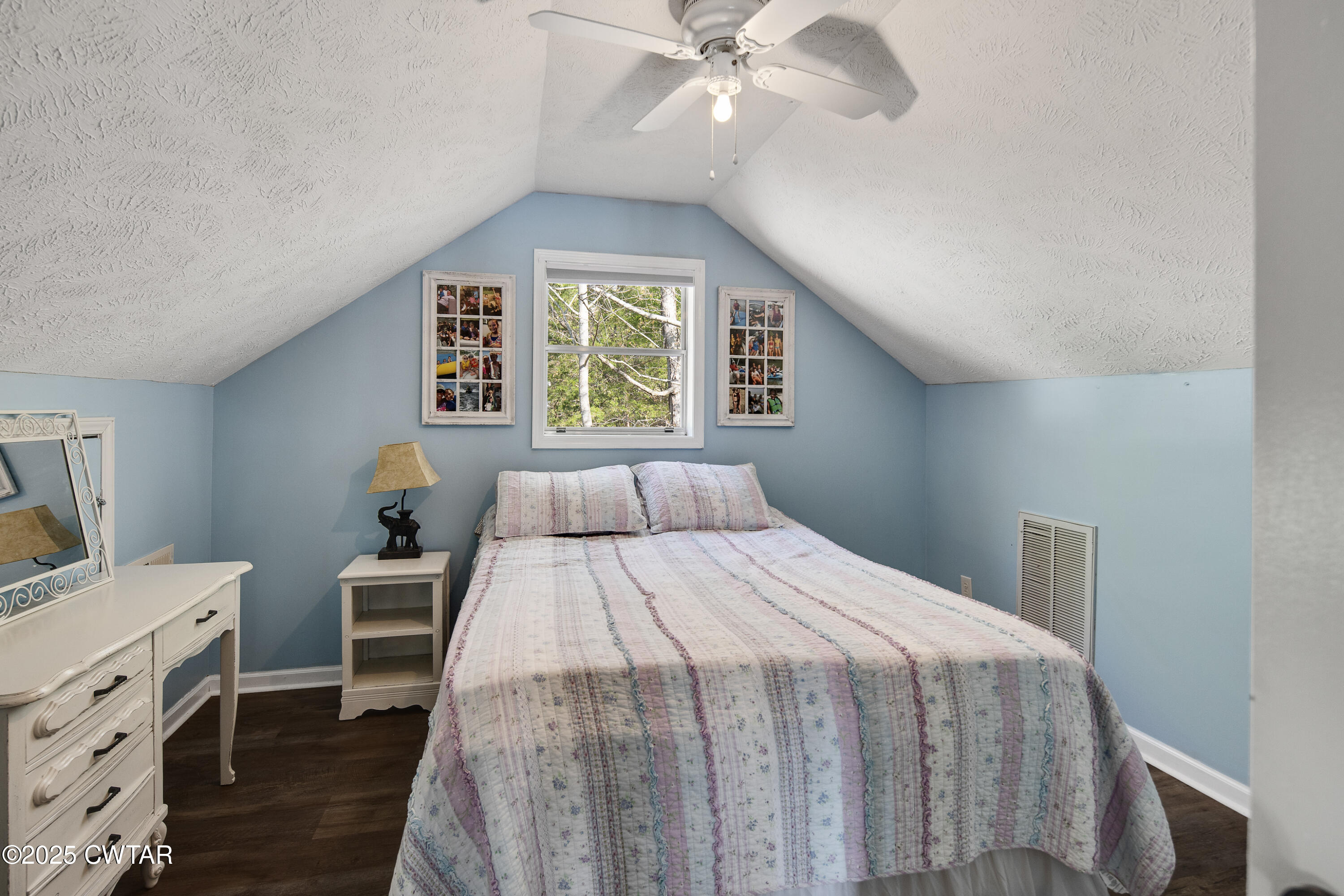 229 Bill Perry Drive Sugar Tree, TN 38380 - Photo 23 of 42 a bedroom with a bed and a chandelier