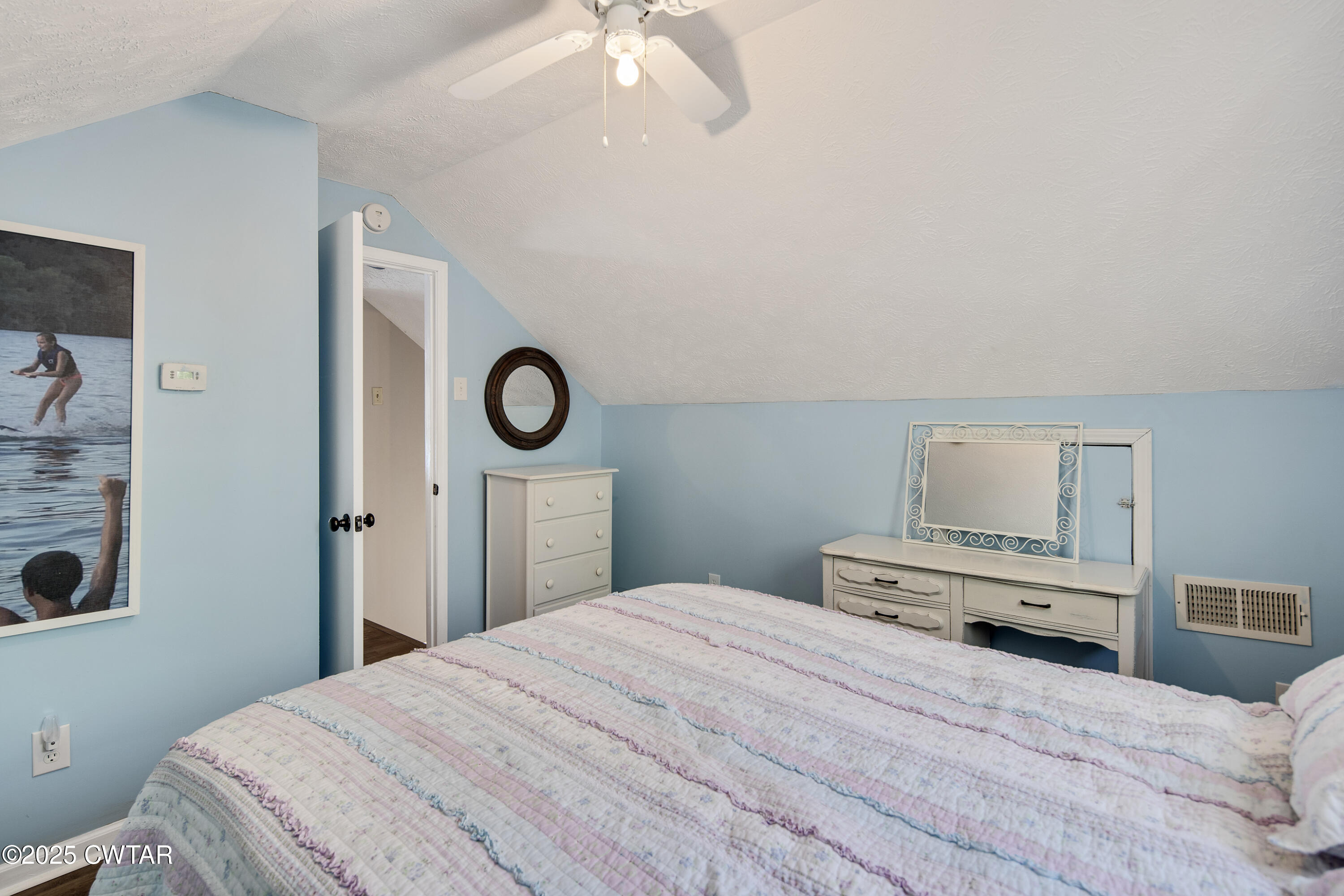 229 Bill Perry Drive Sugar Tree, TN 38380 - Photo 24 of 42 a bedroom with a bed and a chandelier