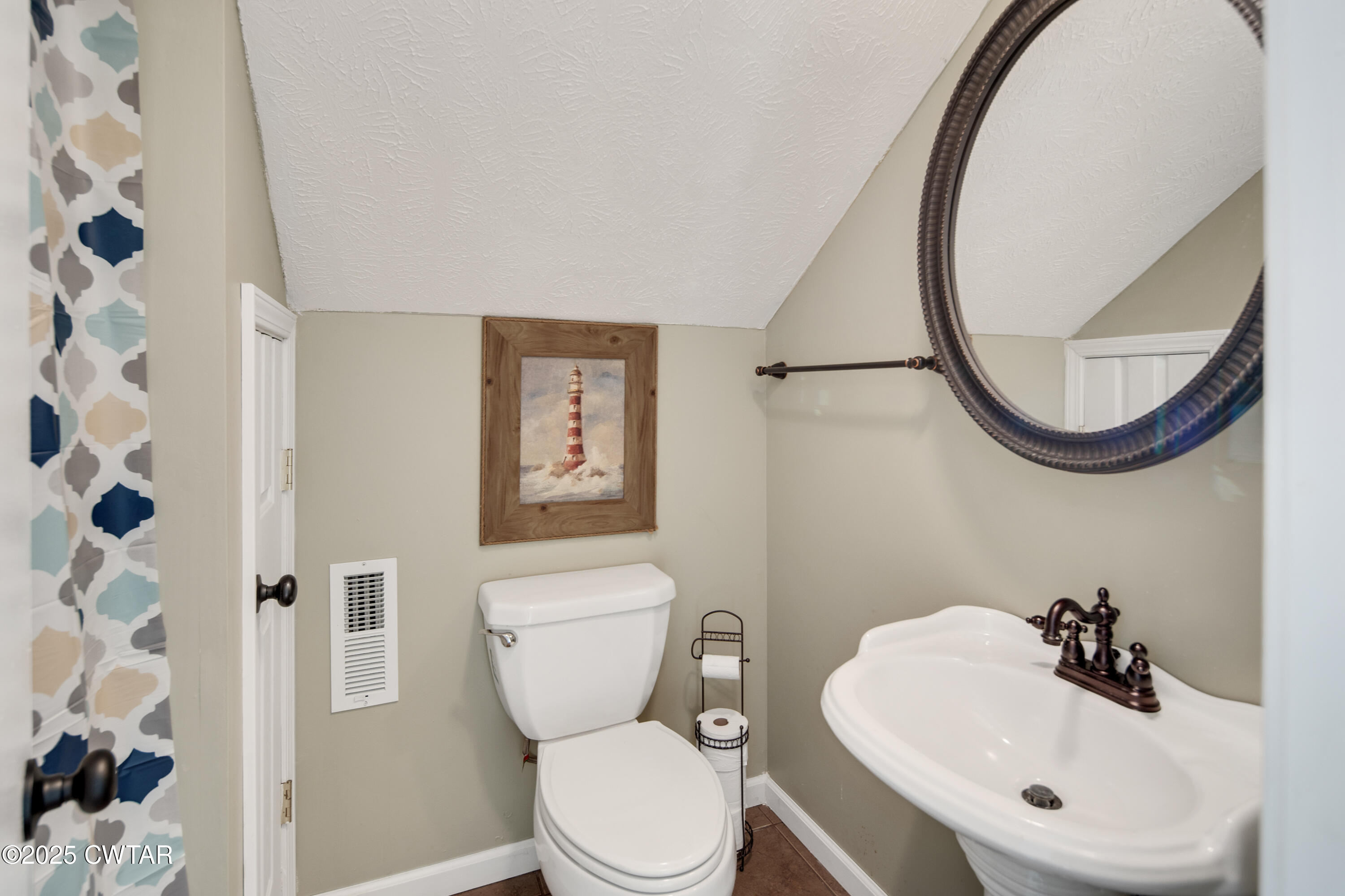229 Bill Perry Drive Sugar Tree, TN 38380 - Photo 25 of 42 a bathroom with a toilet sink and mirror
